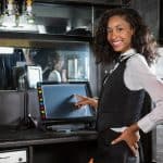 Happy barmaid preparing a bill