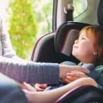 Toddler girl in her car seat